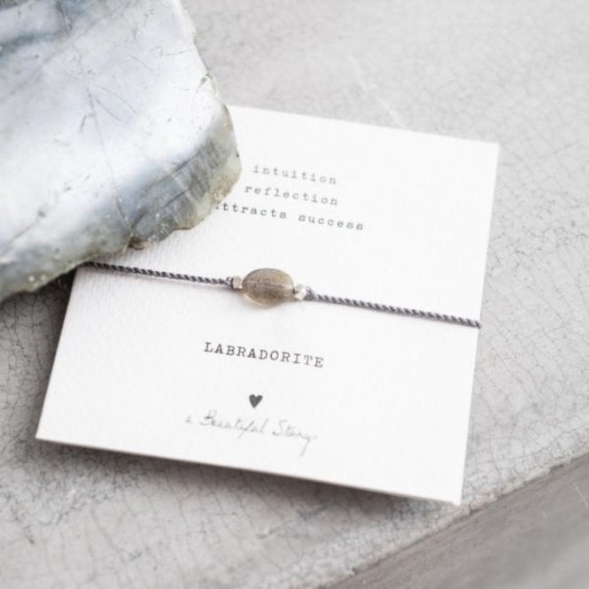 A Beautiful Story, Unlock your strength and sparkle with this beautiful Gemstone Card Labradorite Silver Bracelet! Crafted with a cotton thread and a Labradorite gemstone, this adjustable bracelet will help you become the best version of yourself.